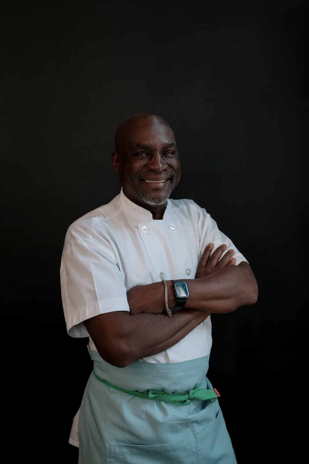 Charles Williams, head chef at Bistro Ten, in chef whites against a dark backdrop