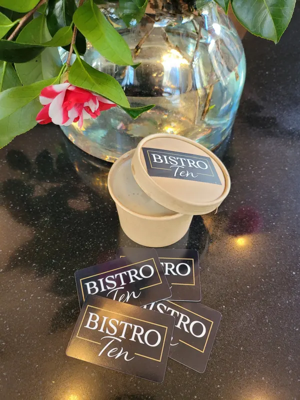 Bistro Ten coasters scattered on a table with flowers